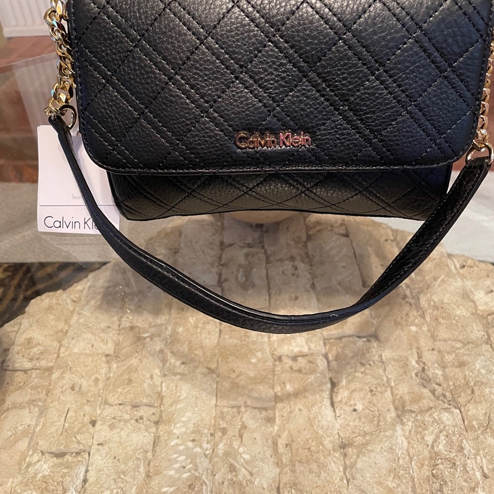 Black Calvin Klein leather flap bag.